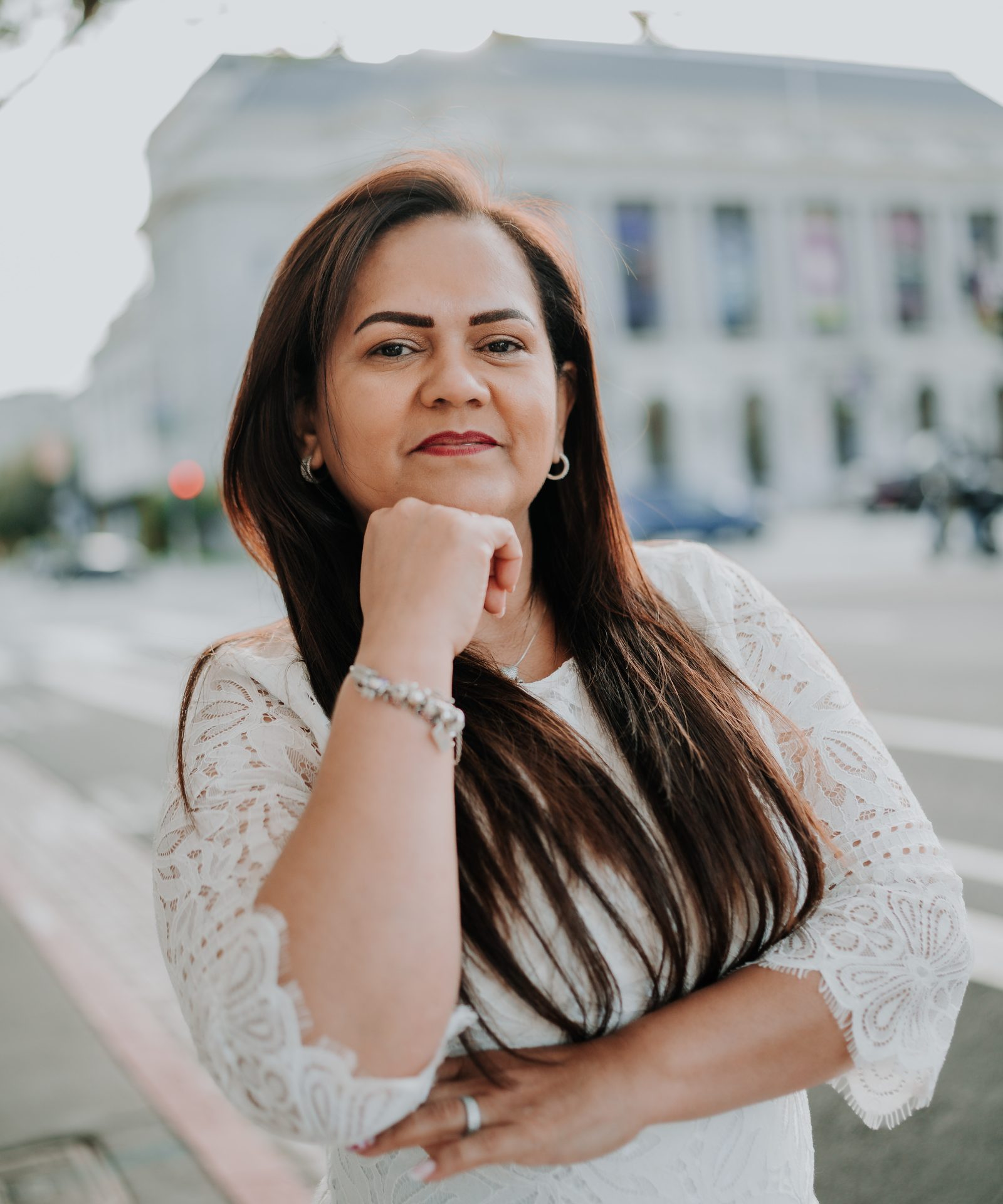 Dorah Andrade, postpartum doula, smiling in front of San Francisco City Hall